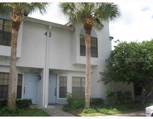 5100 Burchette Road, Unit 4002 Tampa, FL 33647 - Photo 1 of 1 a front view of a house with a yard and garage
