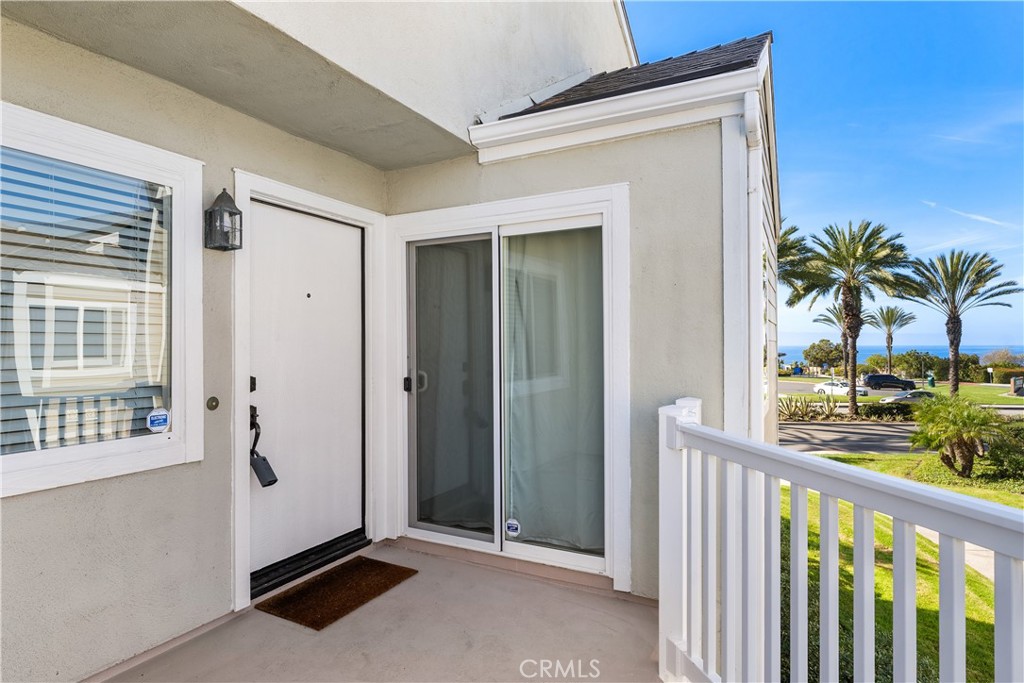34002 Selva Road, Unit 369 Dana Point, CA 92629 - Photo 16 of 29 a view of a porch with a floor to ceiling window and potted plants