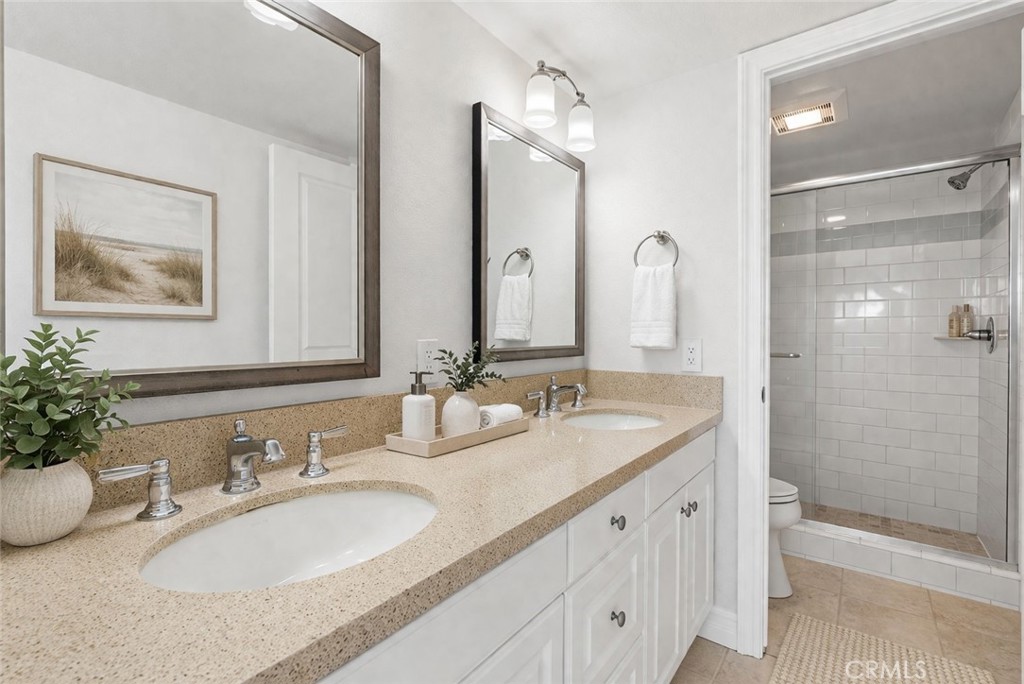 34002 Selva Road, Unit 369 Dana Point, CA 92629 - Photo 8 of 29 a bathroom with a double vanity sink mirror and shower