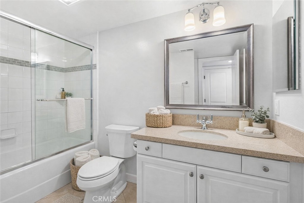 34002 Selva Road, Unit 369 Dana Point, CA 92629 - Photo 9 of 29 a bathroom with a toilet a sink a mirror a vanity and shower