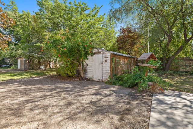 658 Wasatch Street Midvale, UT 84047 - Photo 23 of 31 Gravel surface area with a shed and established trees