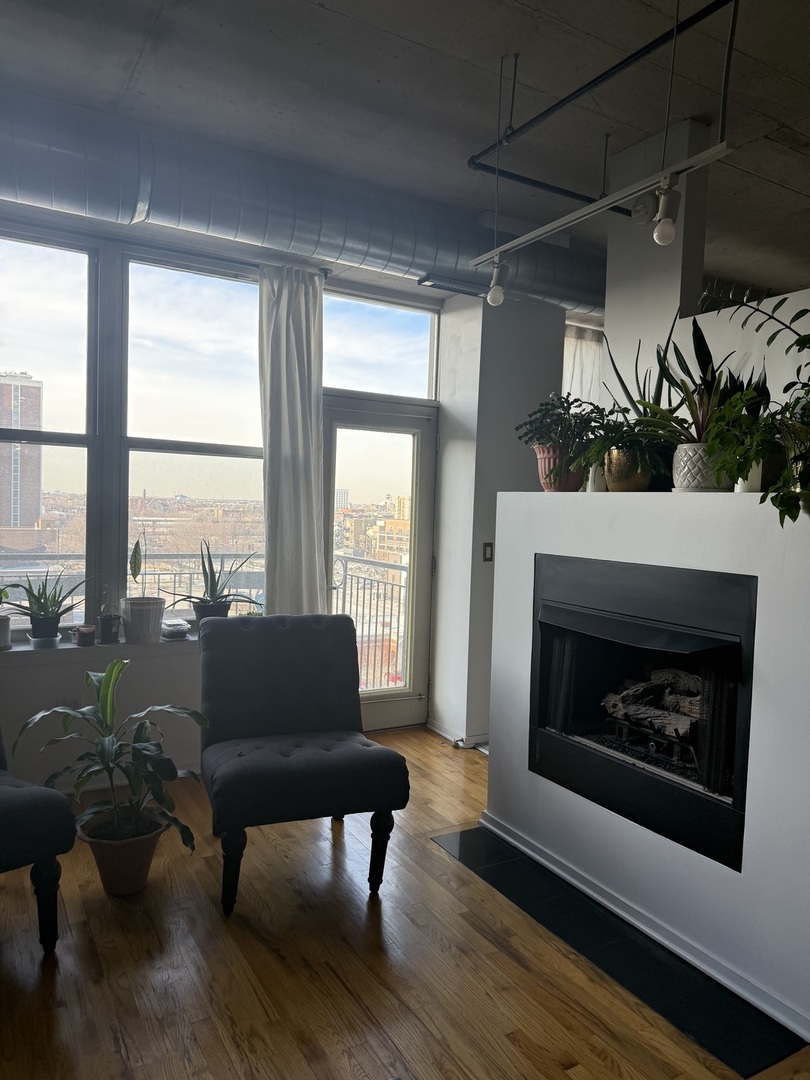 6 South Laflin Street, Unit 716 Chicago, IL 60607 - Photo 8 of 13 a living room with furniture and a fireplace