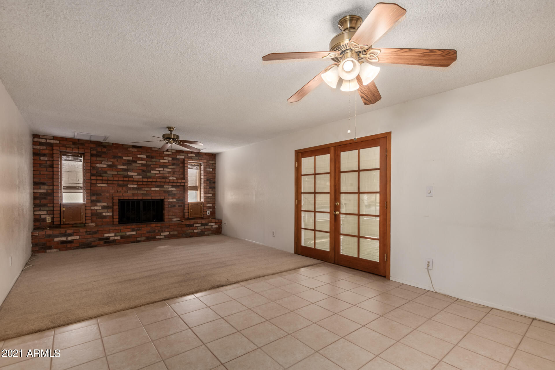 3308 South Newberry Road Tempe, AZ 85282 - Photo 9 of 38 an empty room with windows and fireplace