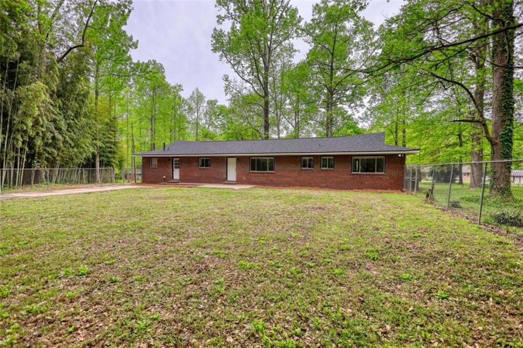 555 Joy Street Jackson, GA 30233 - Photo 5 of 56 front view of a house with a yard