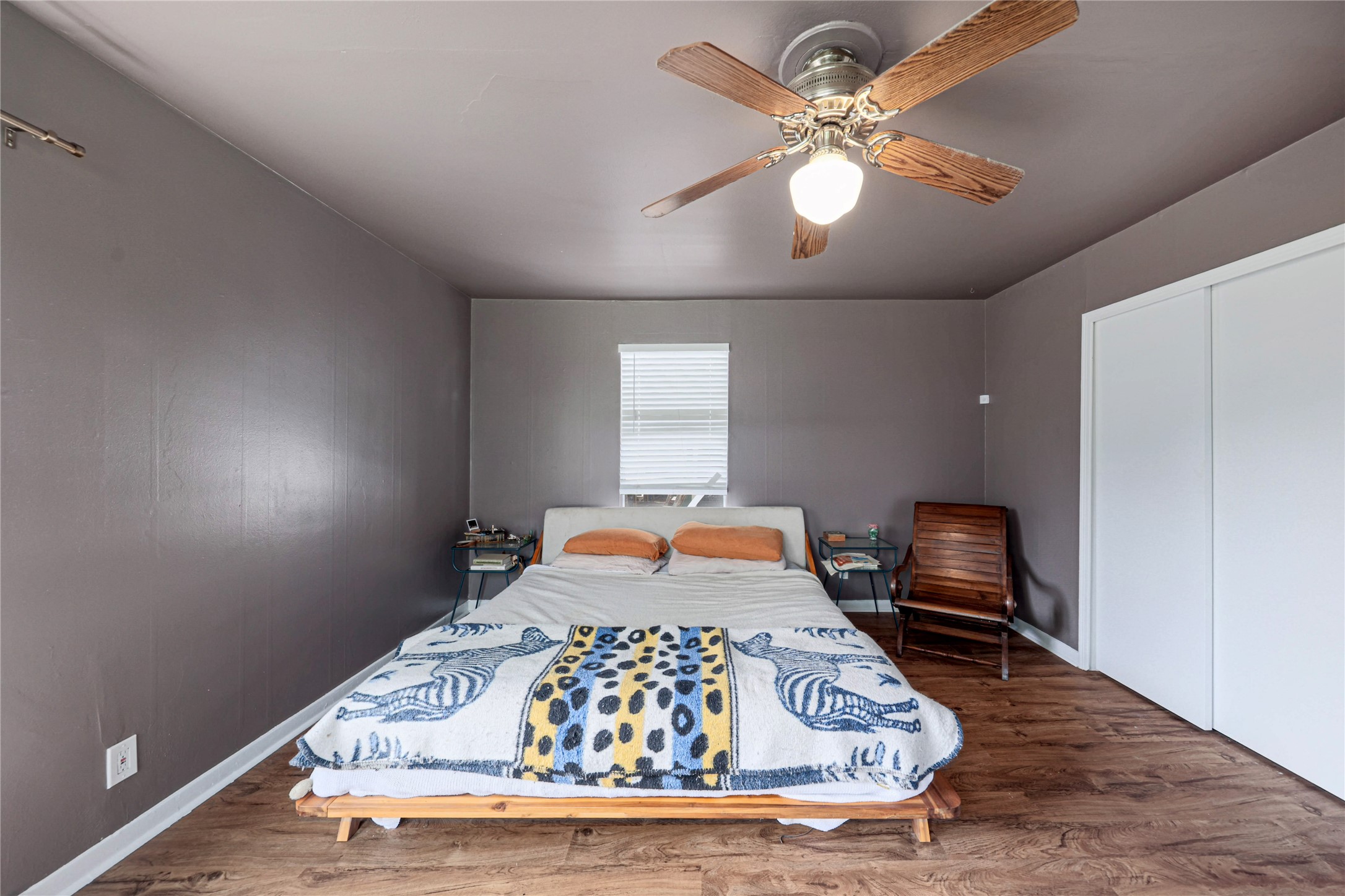 4607 Evans Avenue, Unit B Austin, TX 78751 - Photo 12 of 34 Bedroom featuring wood-finish flooring, a ceiling fan with integrated lighting, a window with blinds, and white sliding closet doors