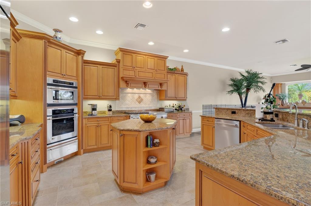 1964 Rialto Way Alva, FL 33920 - Photo 16 of 50 a kitchen with stainless steel appliances granite countertop a sink stove and refrigerator