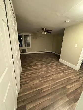 a view of a room with wooden floor and stairs