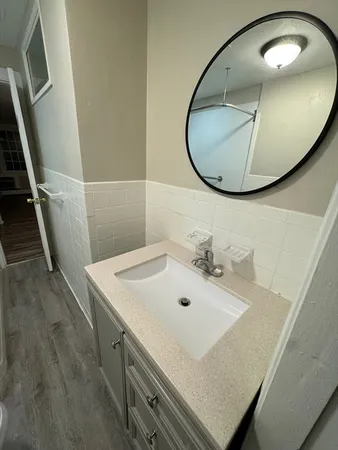 a bathroom with a sink and mirror