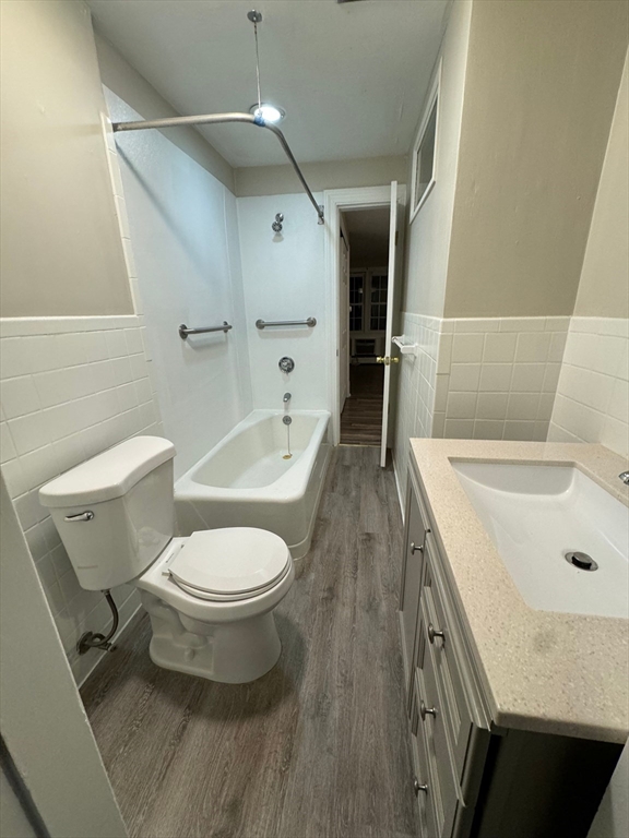 388 East Merrimack Street, Unit 2 Lowell, MA 01852 - Photo 5 of 9 a bathroom with a sink a toilet and shower