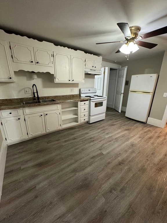 388 East Merrimack Street, Unit 2 Lowell, MA 01852 - Photo 8 of 9 a kitchen with stainless steel appliances sink cabinets and wooden floor