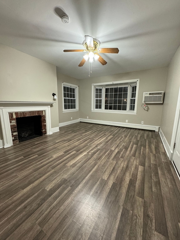 388 East Merrimack Street, Unit 2 Lowell, MA 01852 - Photo 9 of 9 a view of an empty room with wooden floor fireplace and a window