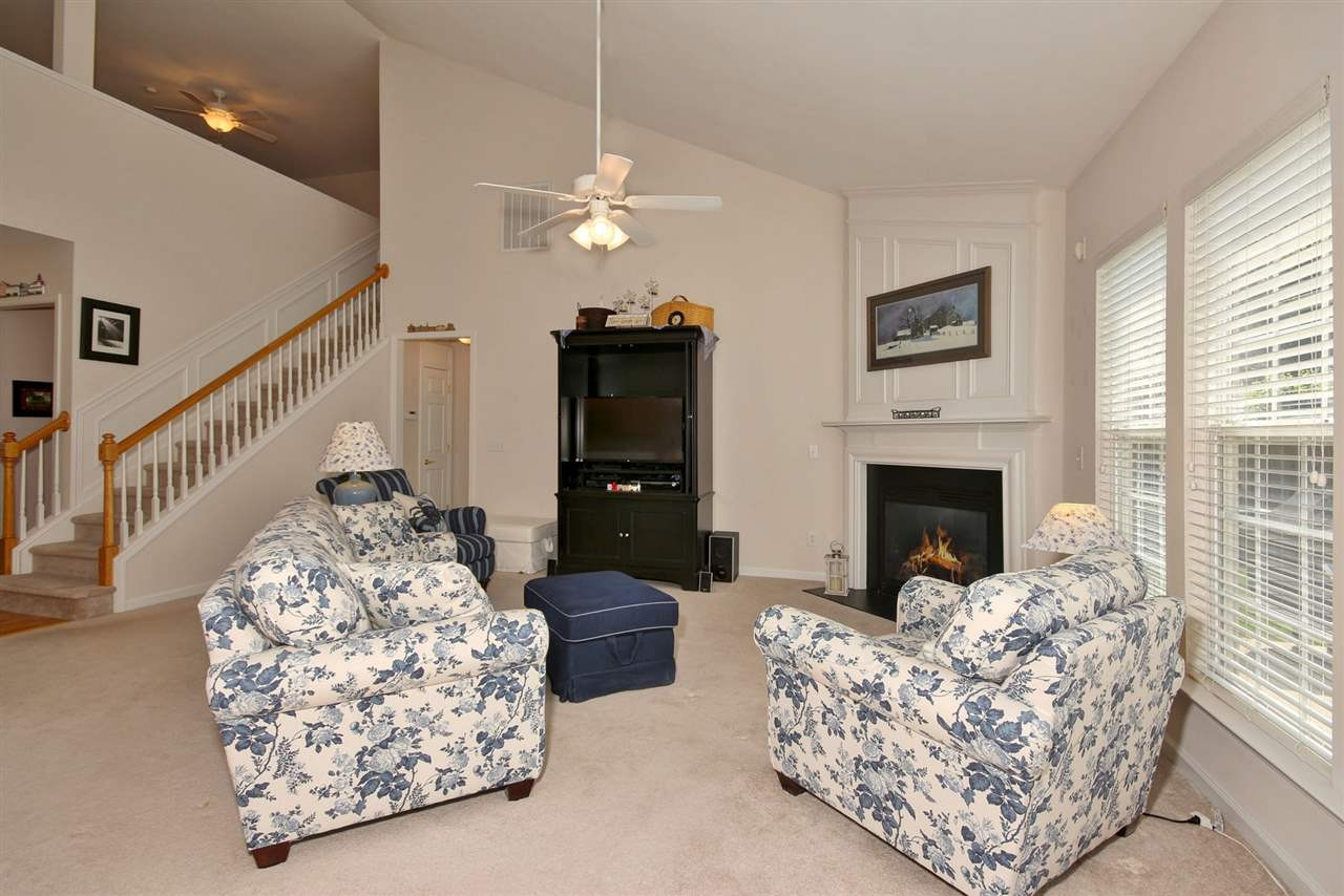 5427 Brandy Bay Road Raleigh, NC 27613 - Photo 6 of 25 Large family room with vaulted ceilings, vast natural lighting and a gas fireplace. Like new carpeting for comfort and a great view of the private backyard. Family Room