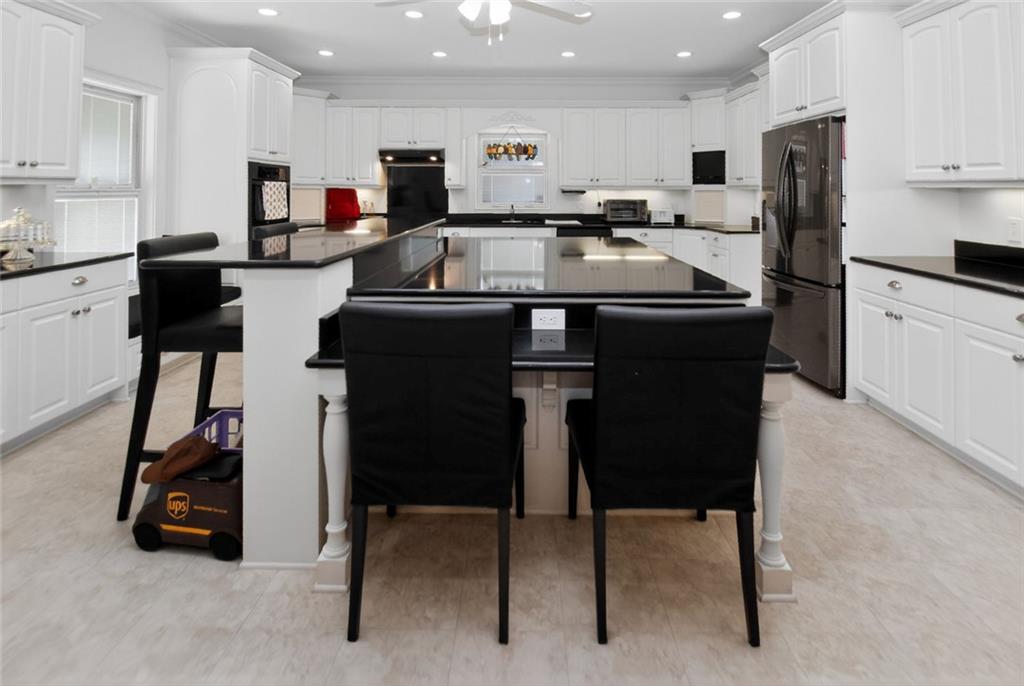 4113 Ledan Extension Gainesville, GA 30506 - Photo 83 of 195 a kitchen with a sink a stove a refrigerator and chairs
