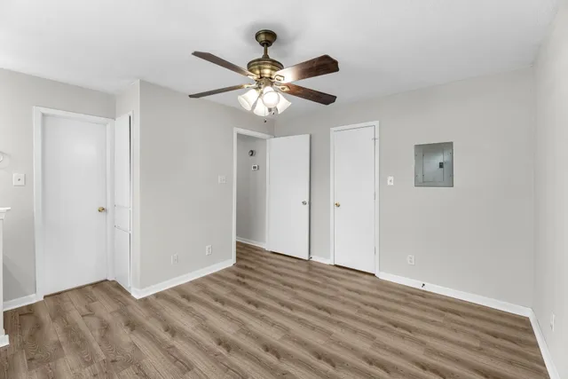 a view of empty room with wooden floor