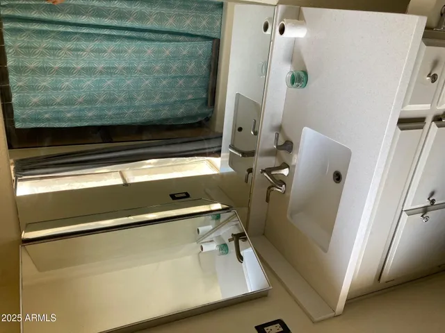 a living room with furniture and a mirror