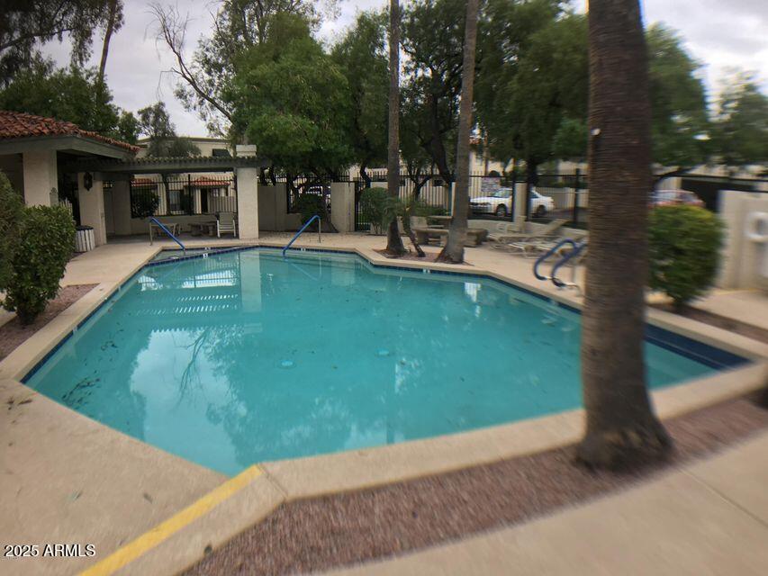 8634 South 51st Street, Unit 3 Phoenix, AZ 85044 - Photo 4 of 18 a swimming pool with outdoor seating and yard