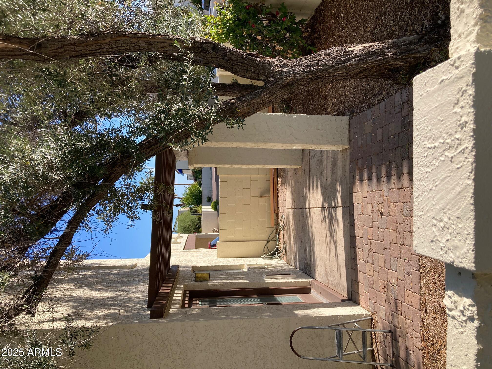 8634 South 51st Street, Unit 3 Phoenix, AZ 85044 - Photo 7 of 18 a backyard of a house with barbeque oven table and chairs
