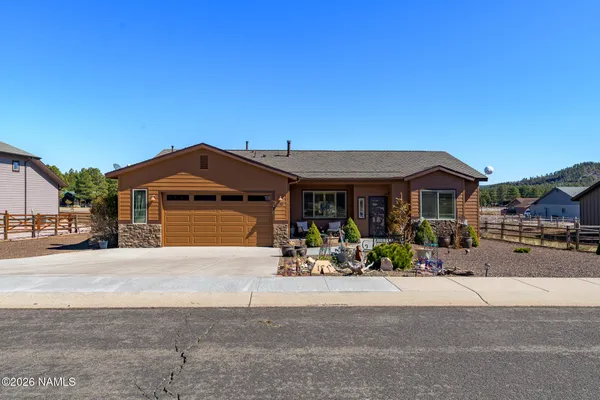 a front view of a house with a yard and a garage
