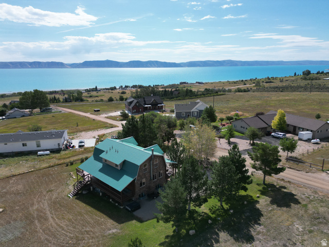 358 Maple Drive Fish Haven, ID 83287 - Photo 34 of 46 Wood-clad exterior with a green metal roof, multiple levels of outdoor decking, and a surrounding natural landscape