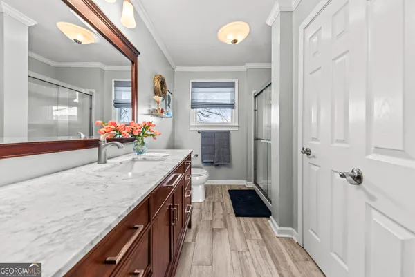 a bathroom with a granite countertop sink a mirror and a bathtub