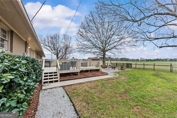 a view of a house with backyard and sitting area