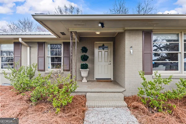a kitchen with stainless steel appliances granite countertop a refrigerator sink and white cabinets