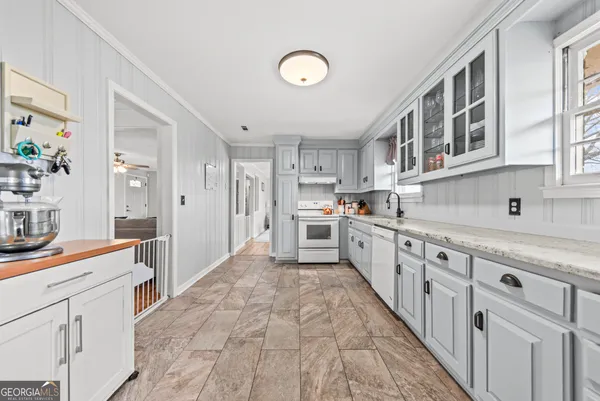 a view of a dining room and livingroom with furniture wooden floor a chandelier