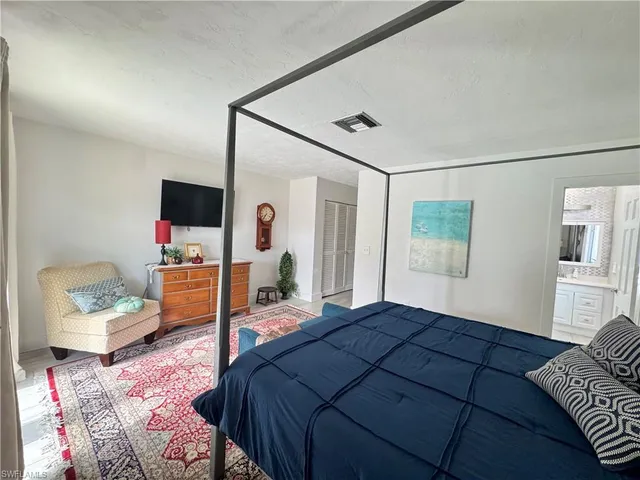 a bedroom with a bed window and couch