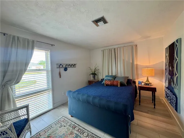 a bedroom with furniture and a window