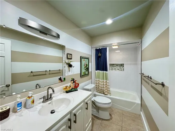 a bathroom with a sink toilet tub and shower