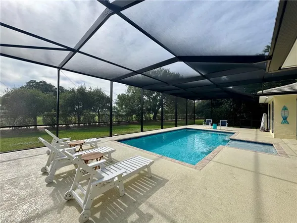 a view of swimming pool with outdoor seating