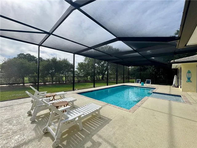 a view of swimming pool with outdoor seating