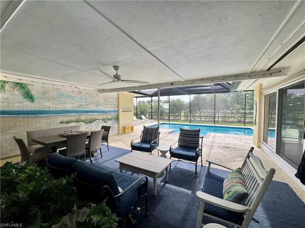 a view of a patio with furniture and a backyard