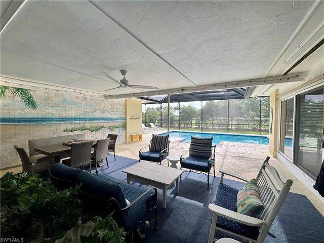 a view of a patio with furniture and a backyard