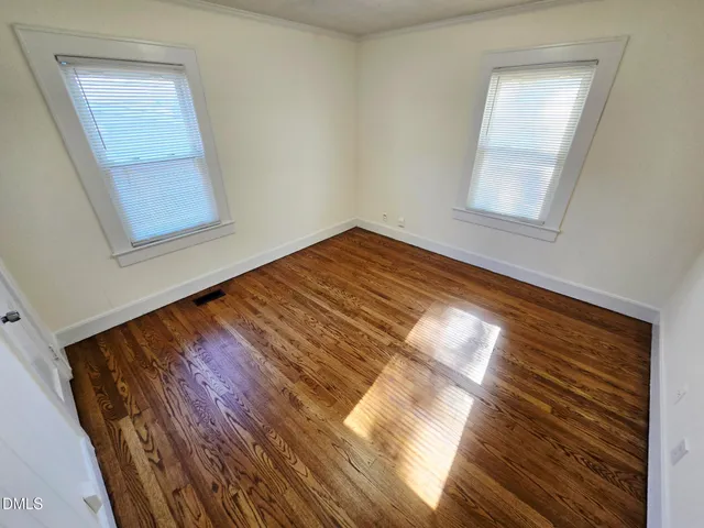 a view of wooden floor and windows in a room