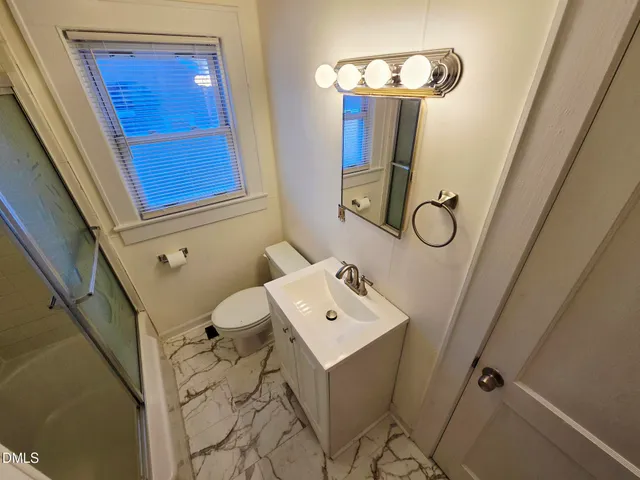 a bathroom with a sink mirror and vanity