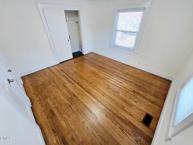 an empty room with wooden floor