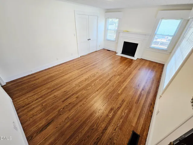 a view of a room with wooden floor