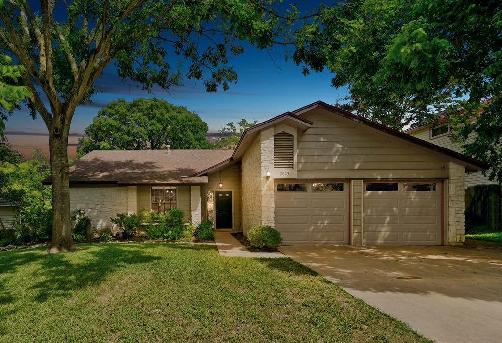 a front view of a house with garden