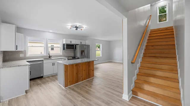 a kitchen with sink microwave and stove
