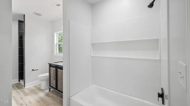 a kitchen with kitchen island a counter top space and stainless steel appliances with cabinets