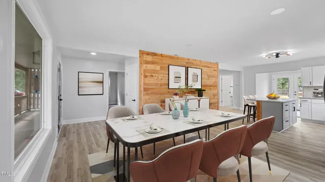 a view of a dining room with furniture and wooden floor