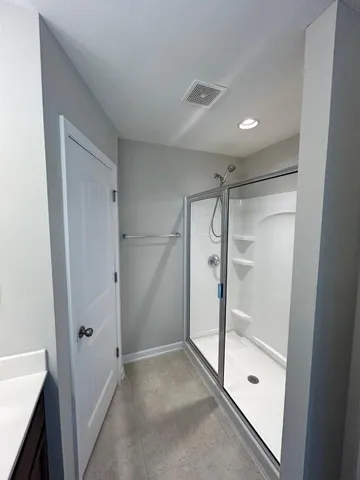 a bathroom with a sink a mirror and a shower