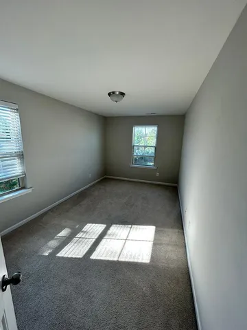 a spacious bathroom with a double vanity sink and mirror