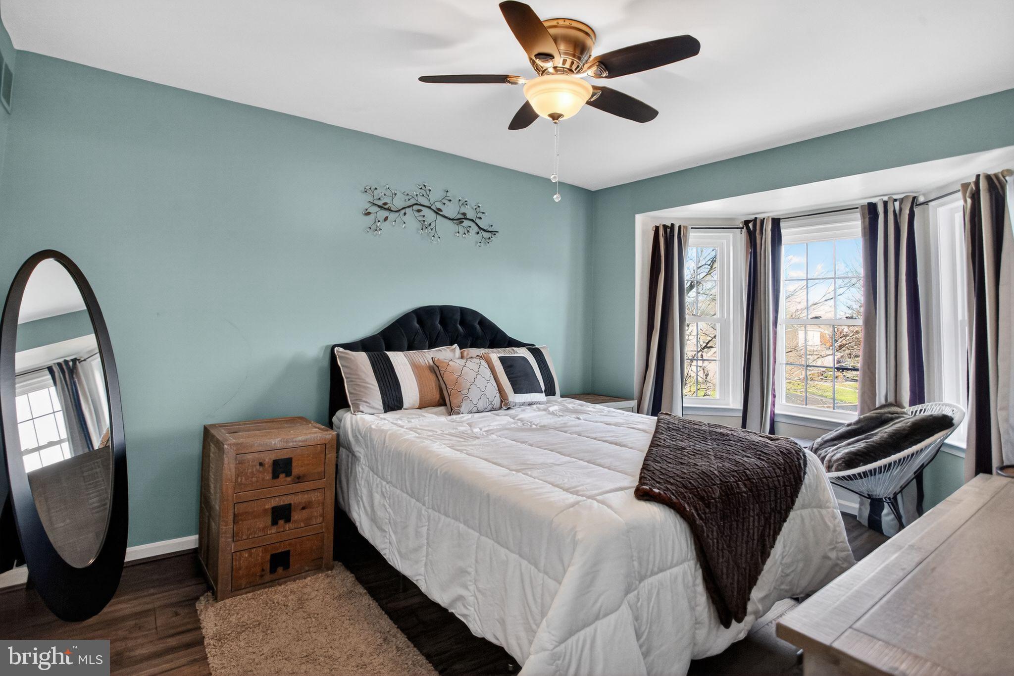 201 Victoria Court Ambler, PA 19002 - Photo 20 of 36 a bedroom with a bed and wooden floor