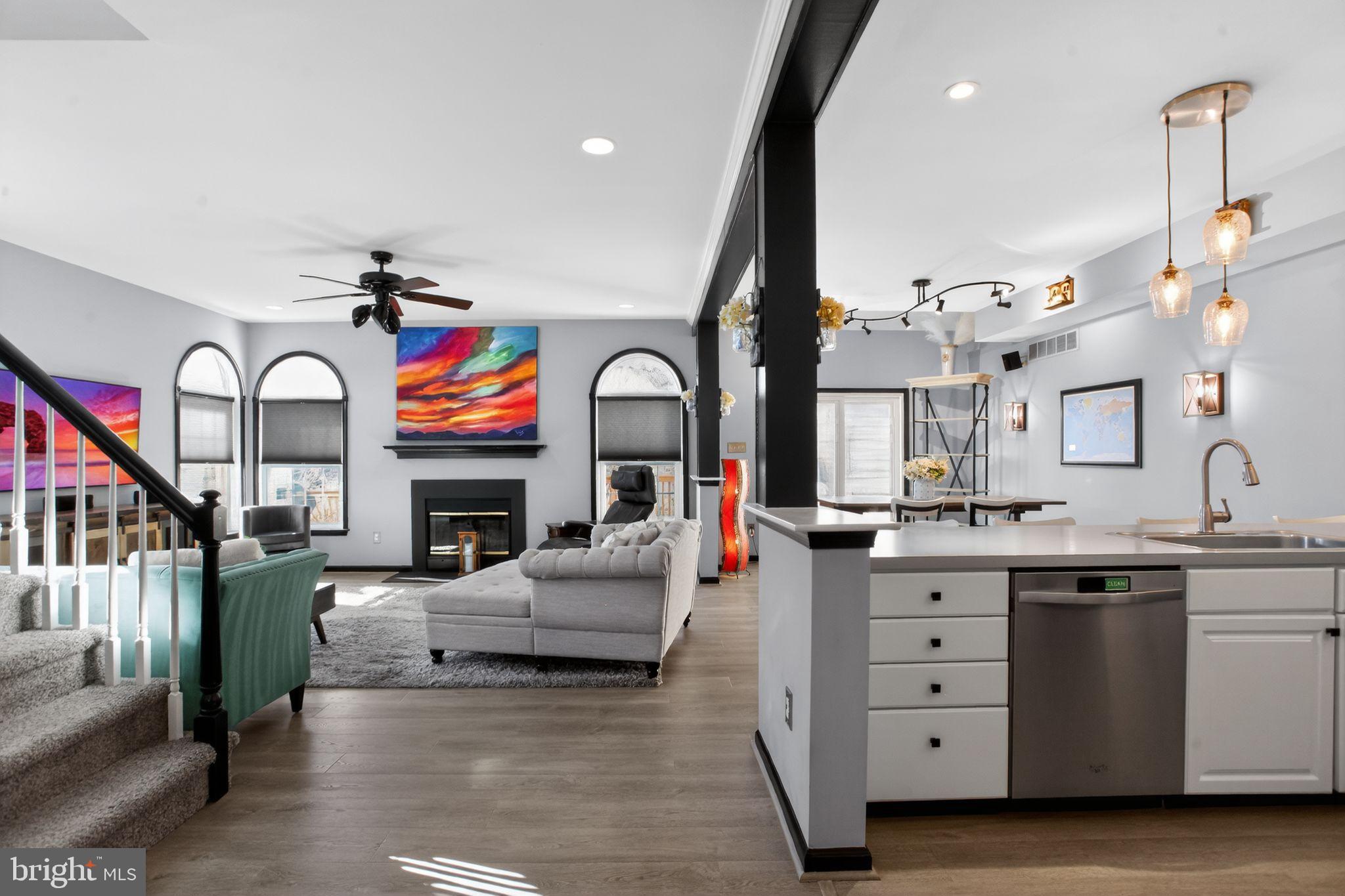201 Victoria Court Ambler, PA 19002 - Photo 6 of 36 a living room with furniture kitchen view and a fireplace