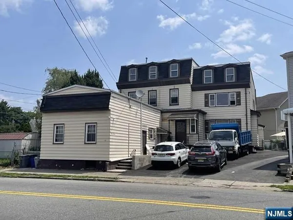 a view of a car park in front of a house