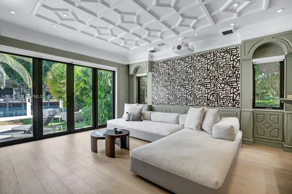 a living room with furniture and a floor to ceiling window