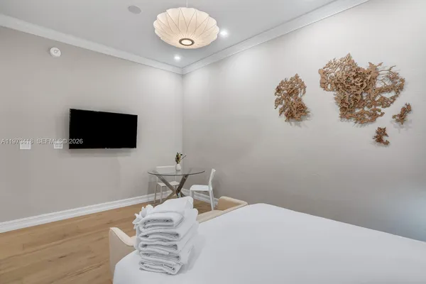 a bedroom with a bed and a flat screen tv