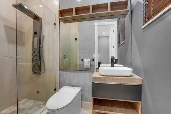 a bathroom with a sink toilet and shower